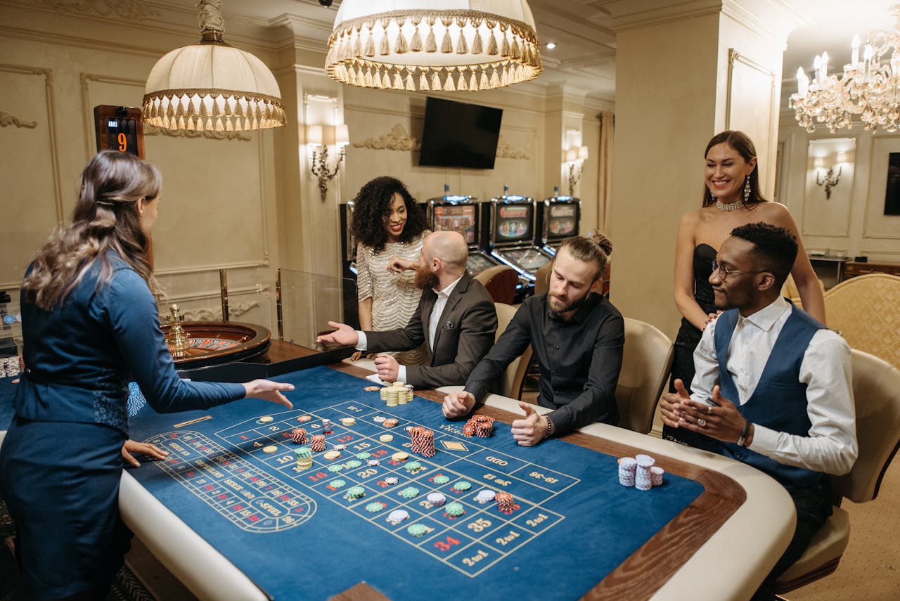 ours-journey Group of people enjoying a lively night at the casino, playing roulette.